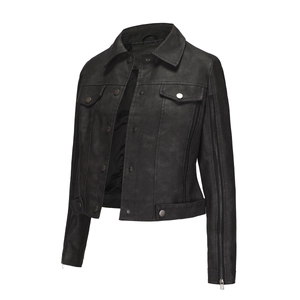 Close-up of black faux leather jacket featuring sleeve zippers and metallic buttons