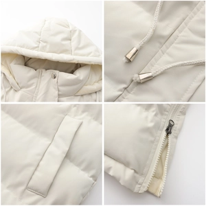 Detail view of the drawstring hood, metal zippers, and side pockets of this beige vest