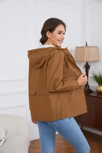 Detail of a brown hooded windbreaker showing the drawstring hood and casual fit for women