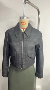 Detail of dark grey vintage washed PU jacket featuring lapel collar and metal zipper