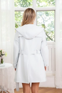 Back view of a long light grey hooded windbreaker with adjustable waist belt and slit hem