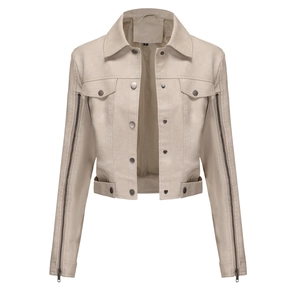 Detail of metal snap buttons and utility chest pockets on beige suede jacket