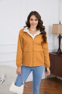 Close-up of ginger hooded windbreaker with metal ring zipper and oversized flap pockets