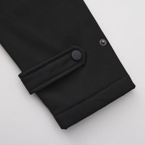 Detail of adjustable cuff with matte black snap button on water-repellent windbreaker