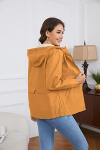 Detail of hooded windbreaker featuring drawstring, large front pockets, and elastic cuffs