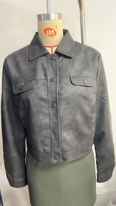 Detailed front view of a dark grey cropped jacket with buttons and utility pockets