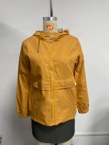 Detail of ginger yellow hooded windbreaker featuring full zipper and metal pull tab