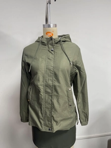 Detailed view of olive green hooded windbreaker with snap button pockets and drawstrings