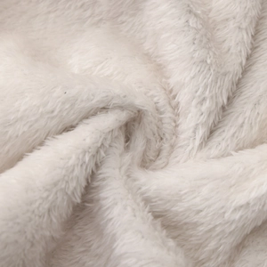 Macro shot of soft white plush fleece fabric with fluffy texture and spiral fiber details