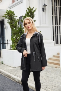 Detail of waterproof black raincoat with striped hood lining and adjustable drawstrings