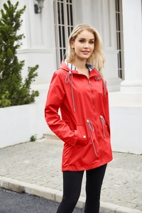 Detail of red hooded raincoat featuring adjustable drawstring waist and striped lining detail