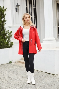 Detail of red water-resistant raincoat featuring adjustable hood and striped lining