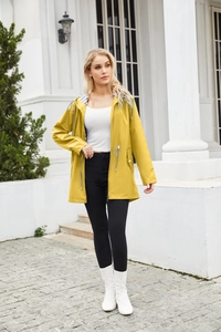 Outdoor shot of a yellow waterproof rain jacket with striped lining and hood