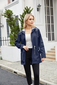 Detail of navy blue hooded raincoat with striped lining and adjustable drawstring waist