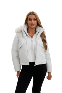 Detail of the high-quality white quilted winter jacket with a luxury faux fur trimmed hood