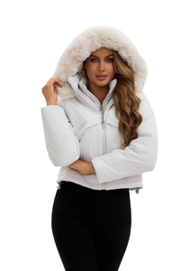 Detail of white hooded puffer coat featuring a thick premium faux fur collar trim
