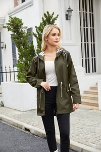 Close-up of military green waterproof raincoat with striped hood lining and white drawstrings