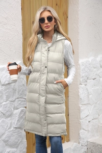 Close-up of hooded quilted vest with silver snap buttons and zipper closure details
