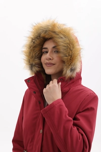 Détail de parka d'hiver rouge avec capuche en fausse fourrure et fermeture éclair