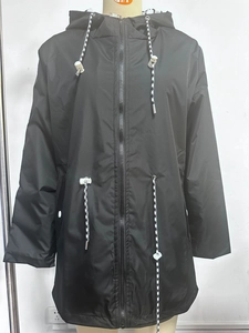 Detail of black hooded raincoat showing adjustable drawstrings and waterproof zipper closure