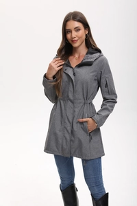 Detail of grey hooded jacket featuring drawstring waist and multiple functional pockets