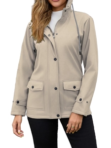 Detail of beige women's hooded windbreaker featuring large flap pockets and button placket
