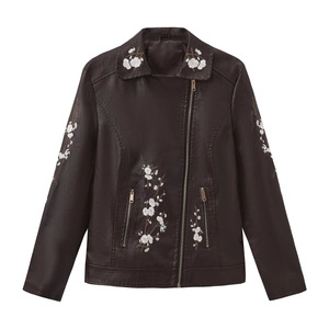 Detailed view of floral cherry blossom embroidery on dark brown faux leather jacket