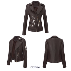 Détail d'une veste en similicuir café avec broderie florale blanche et fermeture éclair