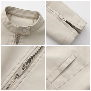 Detail view of beige leather jacket featuring stand collar with snap and metal zipper cuff