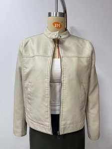 Close-up of cream faux leather jacket featuring stand collar and metal zipper details