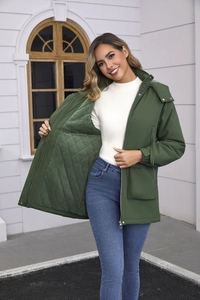 Detailed view of dark green winter parka featuring quilted lining and metal zipper closure