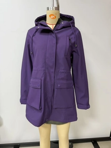 Detail view of the purple hooded rain jacket showing functional flap pockets and drawstring hood
