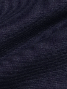 Macro detail of high-quality dark blue knitted fabric showing texture and soft material