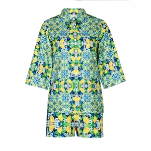 Detail of summer two-piece set featuring yellow lemon and blue tile print on fabric