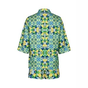 Detailed flat lay of summer set featuring lemon and Mediterranean tile print patterns