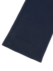 Detail of clean hemline stitching on navy blue cotton linen jumpsuit fabric