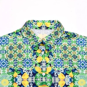 Detail of Mediterranean lemon and blue tile print on a casual summer shirt fabric
