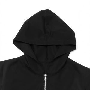 Close-up of black hooded windbreaker with silver metal zipper and drawstring detail