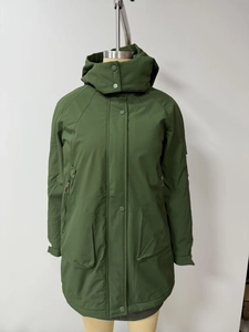 Detail view of dark green hooded parka coat with functional multi-pockets and storm flap