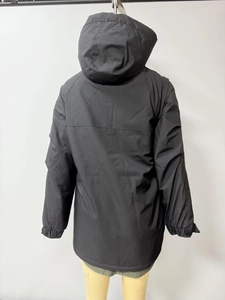 Macro shot of the back view of a black waterproof jacket with reinforced stitching and hood
