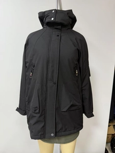 Detail of a black hooded parka jacket featuring windproof material and secure metal snaps