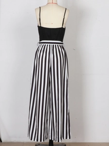 Rear view of striped wide leg jumpsuit with thin straps on a mannequin stand