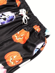 Detail of Halloween pumpkin print trousers with elastic waistband and white drawstring