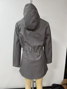 Detail view of adjustable drawstring waist and zippered sleeve pocket on dark gray jacket