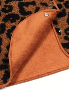 Close-up of leopard fleece jacket with orange suede lining and silver snap button