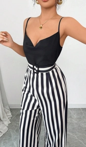 Close-up of black V-neck top and high-waisted vertical striped wide-leg pants with belt