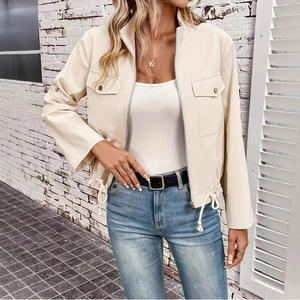 Detail of cream faux leather jacket showing adjustable drawstring hem and cargo pockets