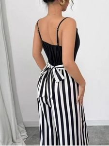 Sleeveless black V-neck top and high waist vertical striped wide leg jumpsuit with bow