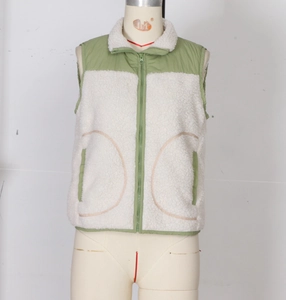 Détail du gilet polaire blanc avec patchwork de tissu vert et fermeture éclair avant