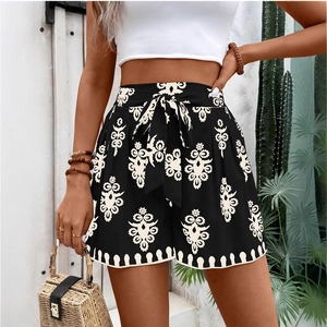 Detail of high waisted printed shorts with ethnic pattern and waist tie for a resort look